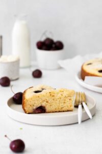 A cherry ricotta cake slice on a plate.