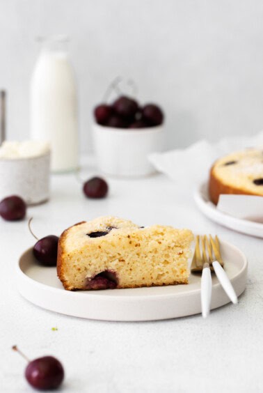 A cherry ricotta cake slice on a plate.