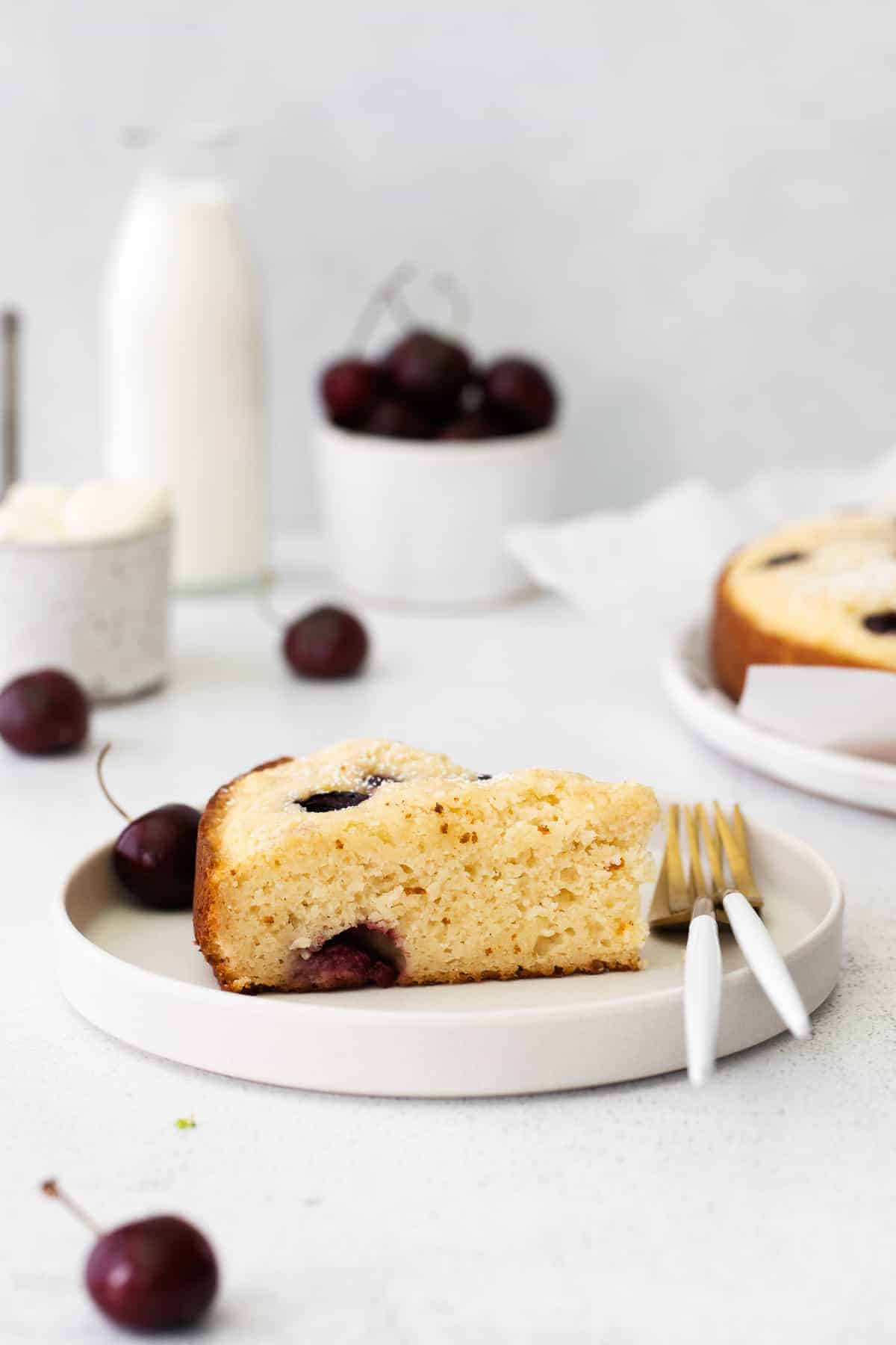 Slice of cherry ricotta cake on counter.