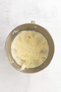 A mixing bowl filled with a delicious mixture of flour and butter, ready for a cherry ricotta cake.