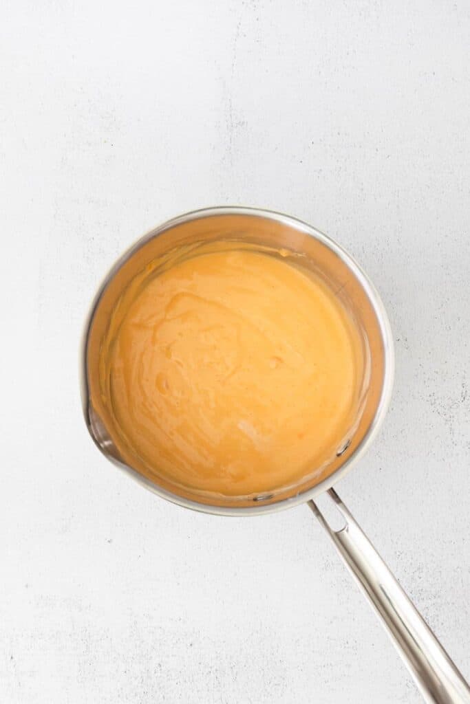 Nacho cheese sauce in a saucepan. 