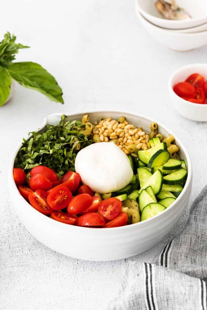 another view of pesto pasta salad with burrata in a bowl