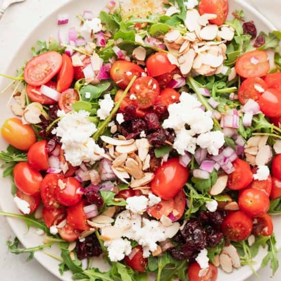 a plate of arugula salad with feta cheese