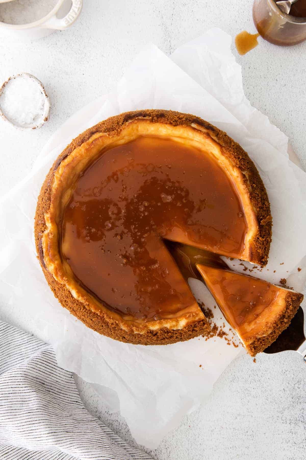 Cutting a piece of salted caramel cheesecake. 