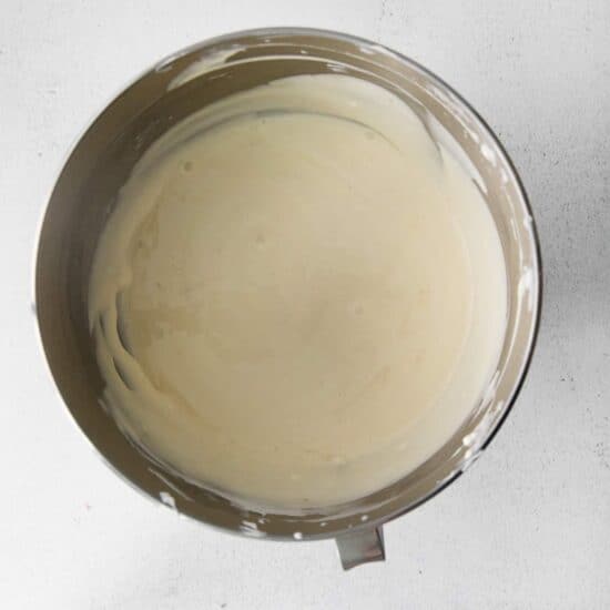 a bowl of white batter on a white surface.