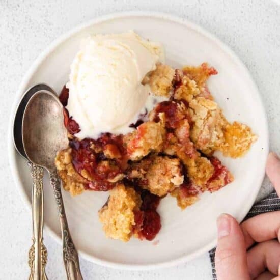 a plate of cream cheese cherry dump cake