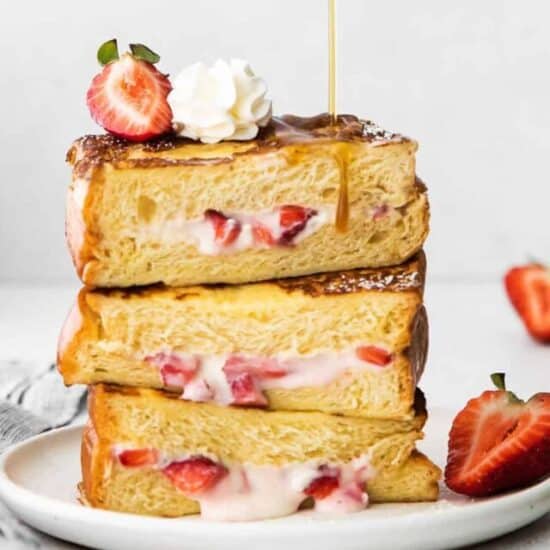 a stack of strawberries and cream french toast