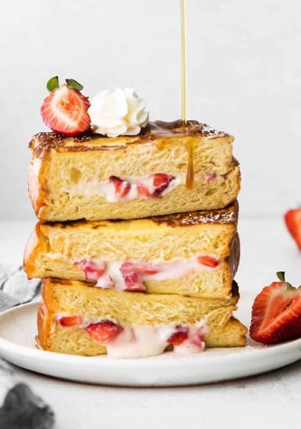 a stack of strawberries and cream french toast