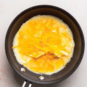 a cheese omelette frying in a pan.