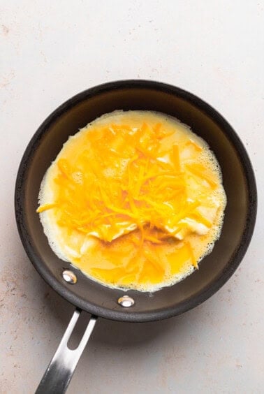 a cheese omelette frying in a pan.