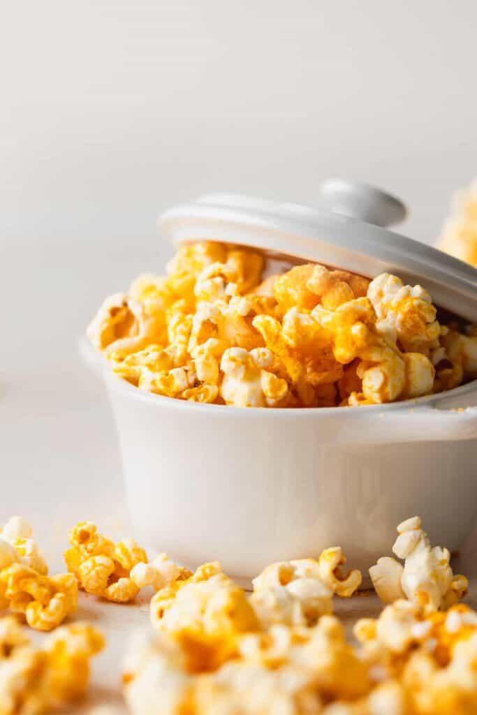 A dish full of cheese popcorn. 