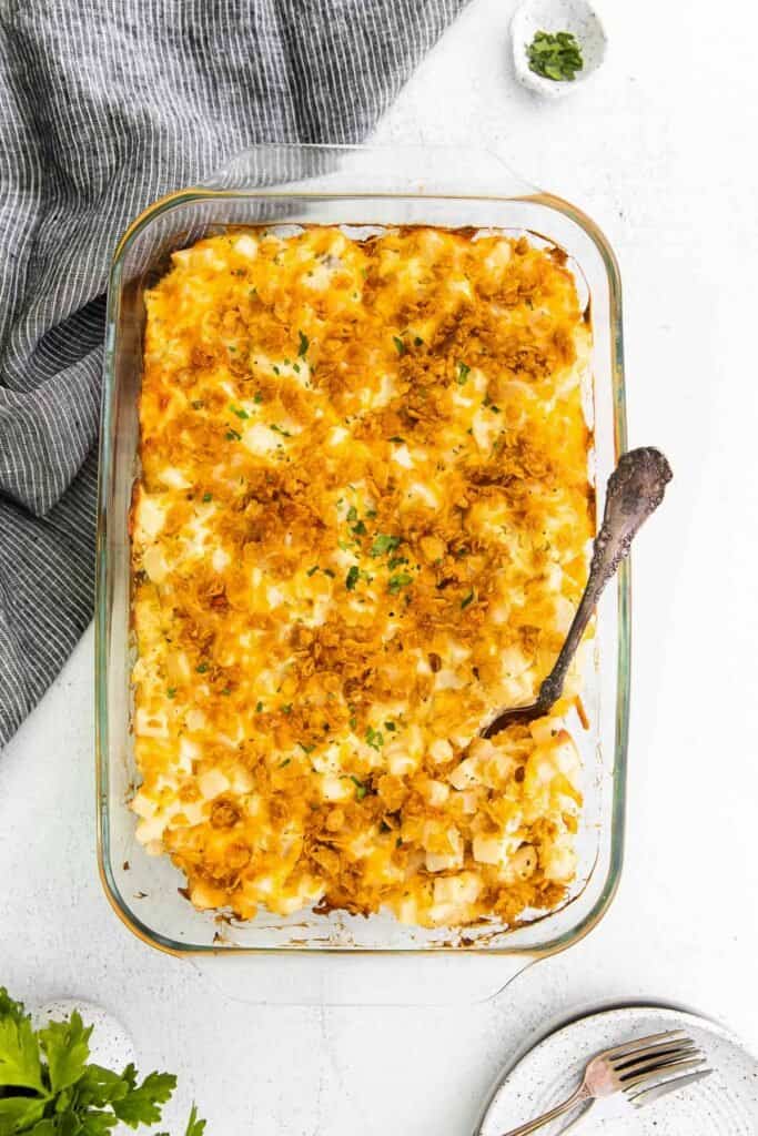 Cheesy potato hashbrowns in casserole dish.