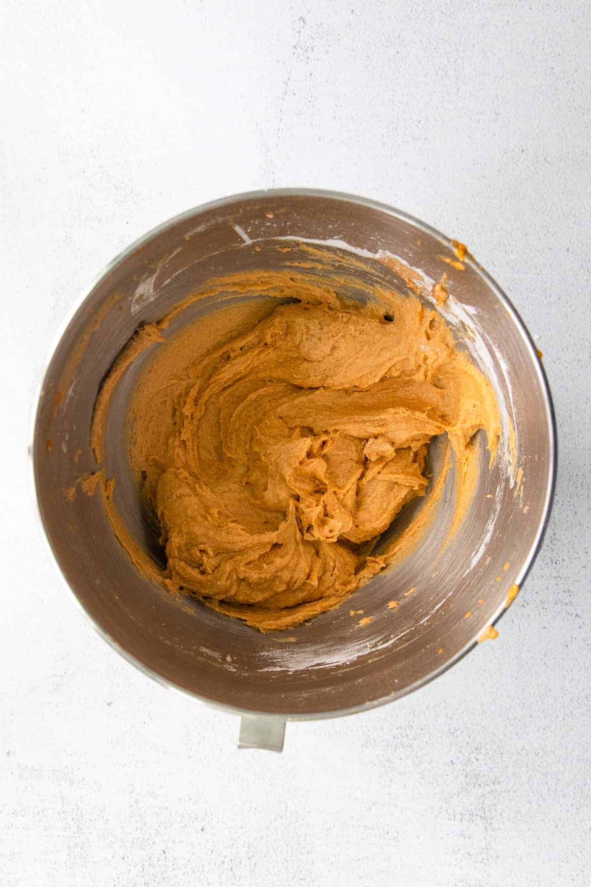 pumpkin cream cheese batter in a stand mixer bowl.