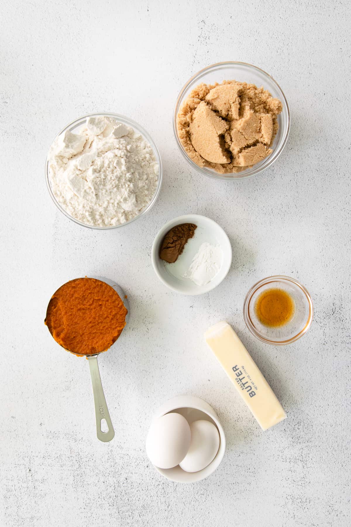 pumpkin cream cheese bread ingredients in small bowls.