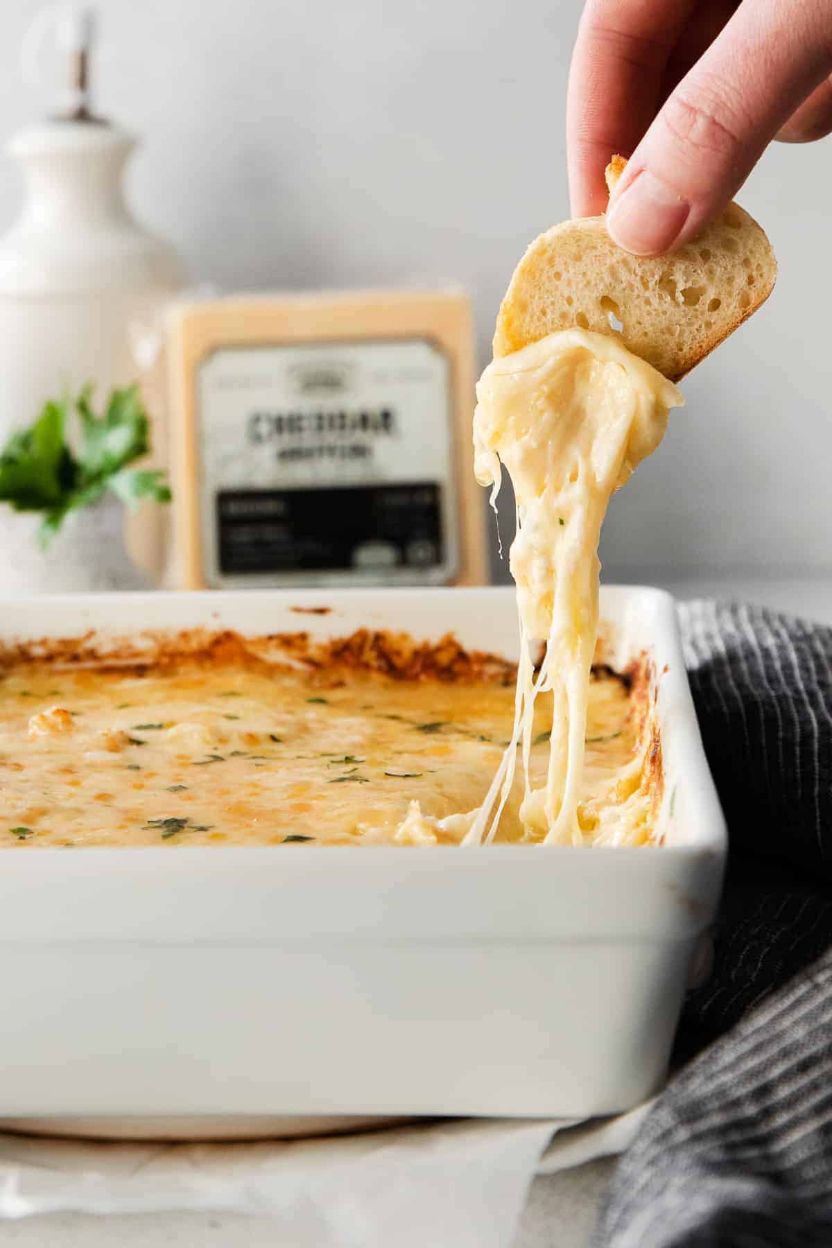 French onion dip with melty cheese on a crostini.