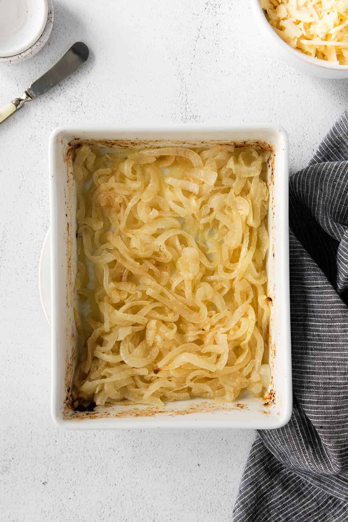 Yellow onions in a casserole dish.