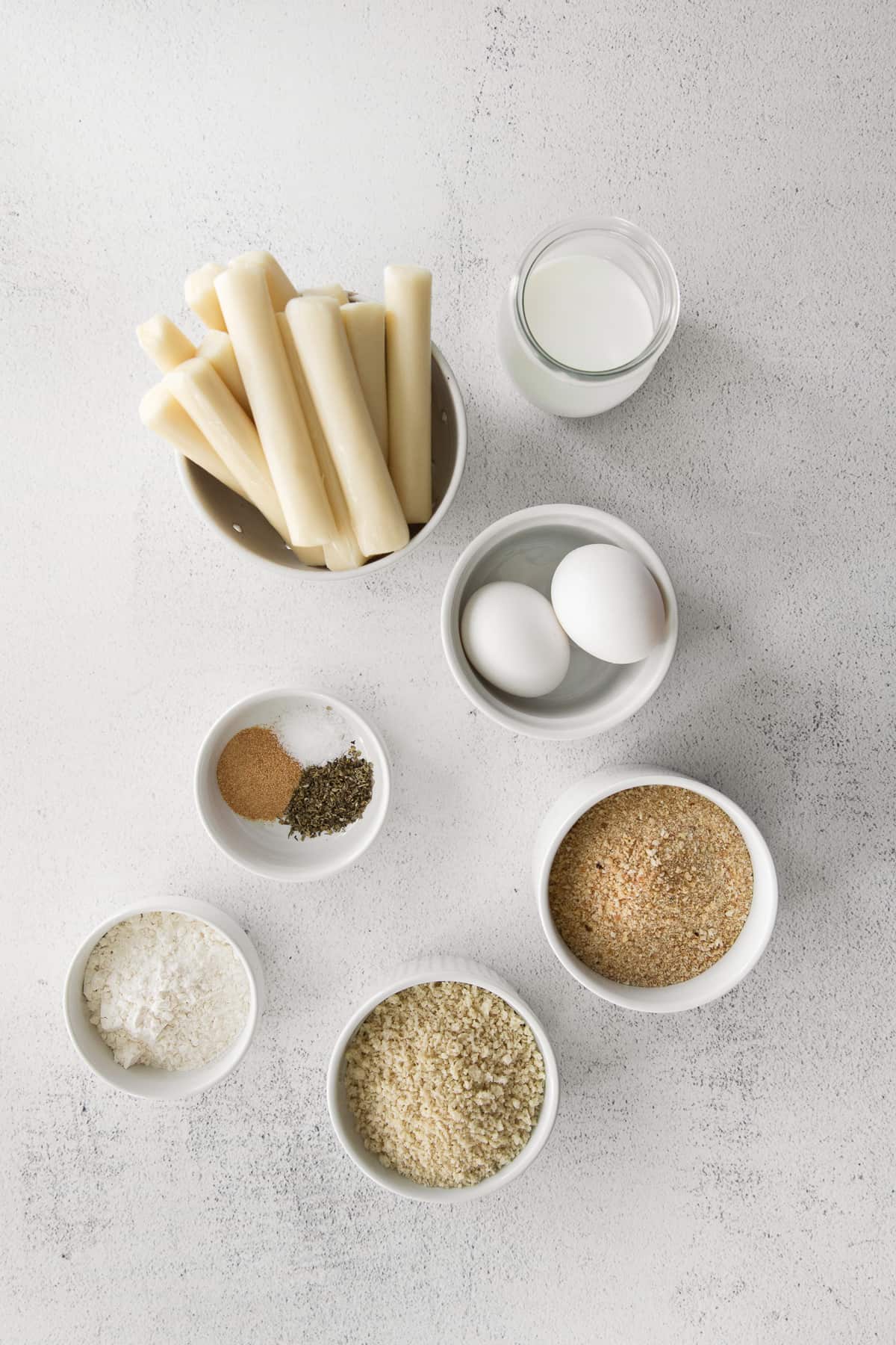 homemade mozzarella sticks ingredients in bowls