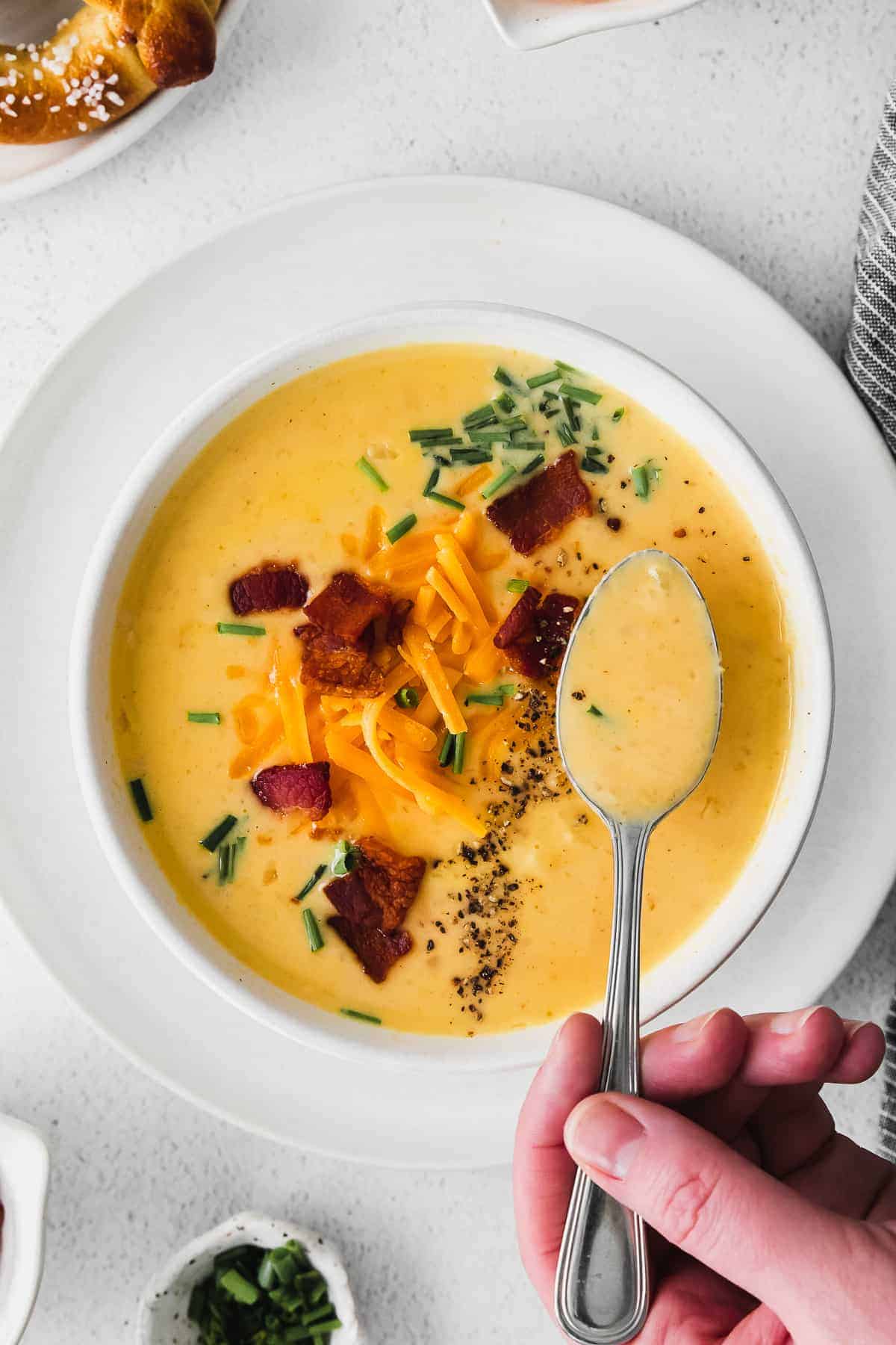 beer cheese soup in a bowl with a spoonful ready to be eaten