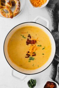 Cheesy beer cheese soup with bacon and pretzels.