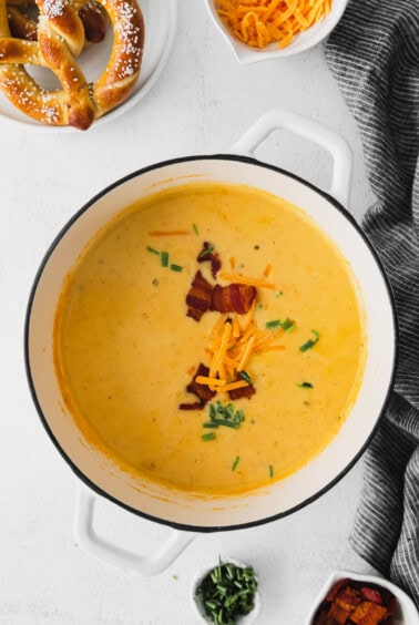 Cheesy beer cheese soup with bacon and pretzels.
