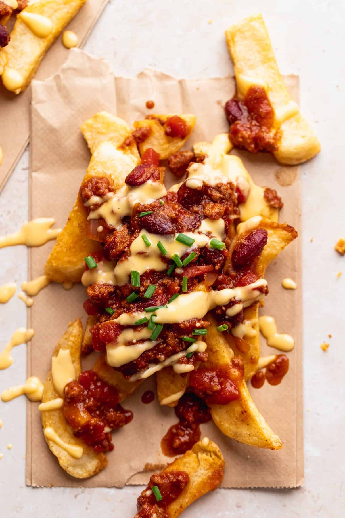 chili cheese fries topped with fresh chopped chives 