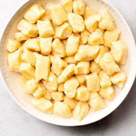 a white bowl filled with cubes of custard.