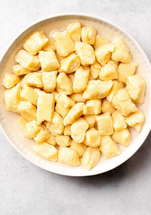 a white bowl filled with cubes of custard.