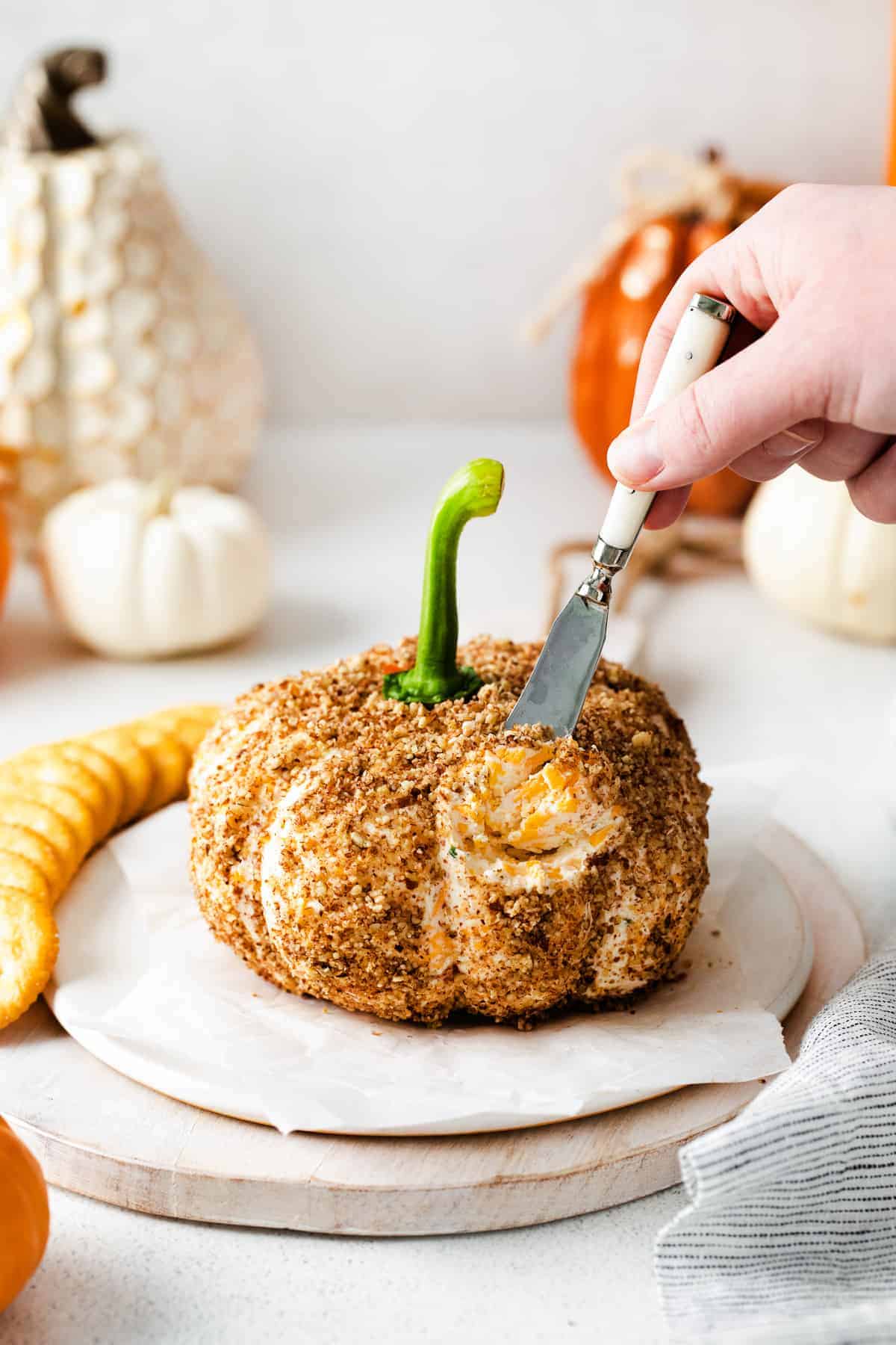 Pumpkin shaped cheese ball.