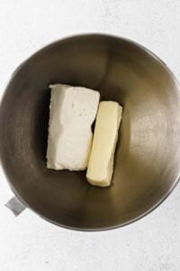 two pieces of butter in a metal bowl.