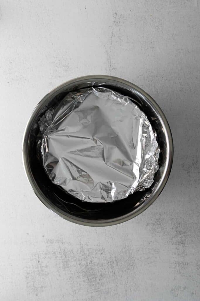 cheesecake covered in aluminum foil and placed into the instant pot
