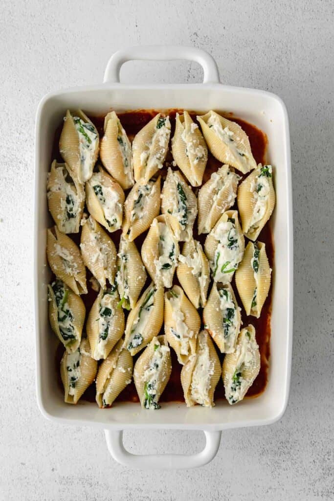 stuffed shells in a casserole dish before being baked