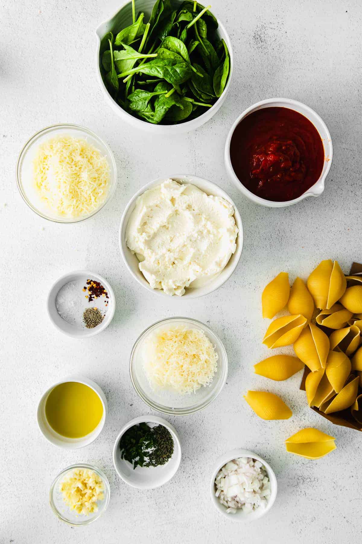 ingredients for stuffed shells in small bowls, ready to be mixed together