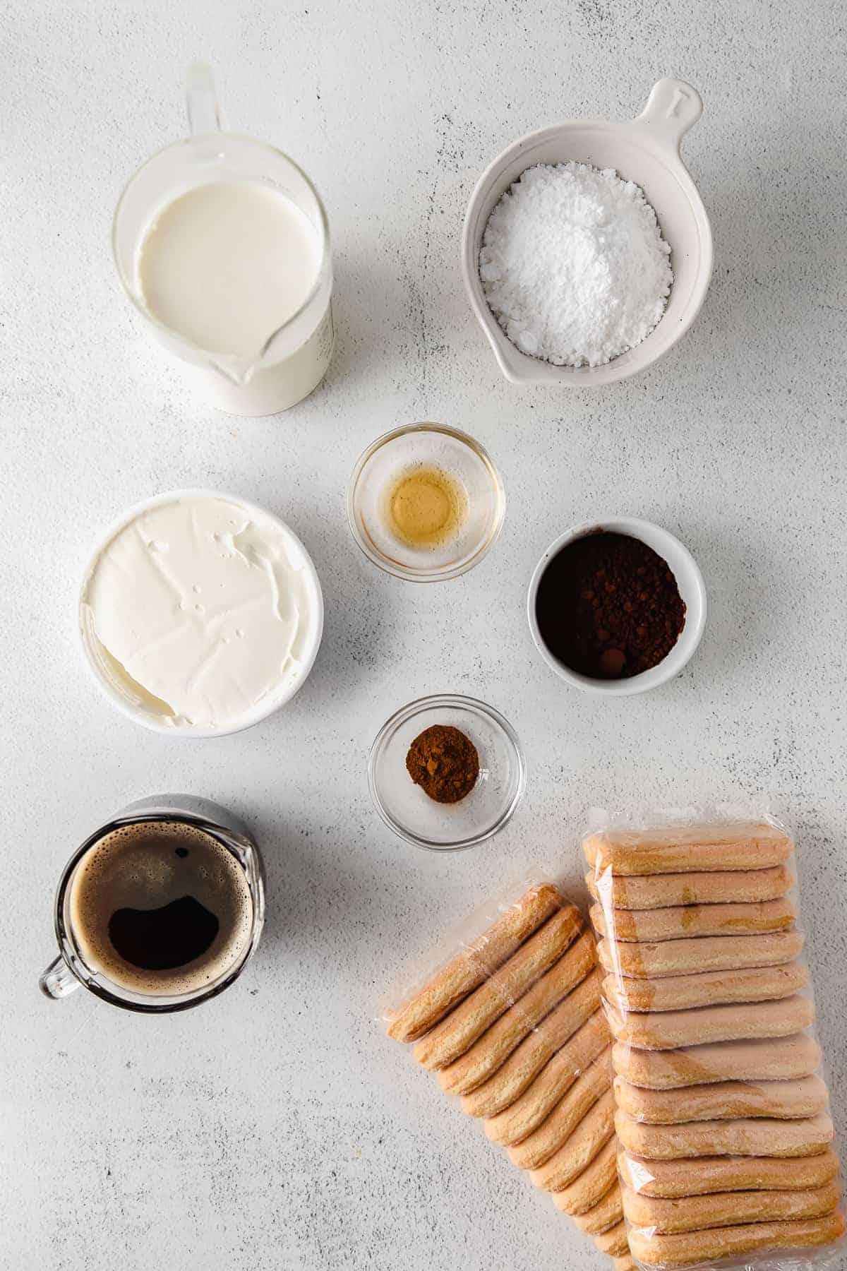 Tiramisu ingredients in small bowls. 