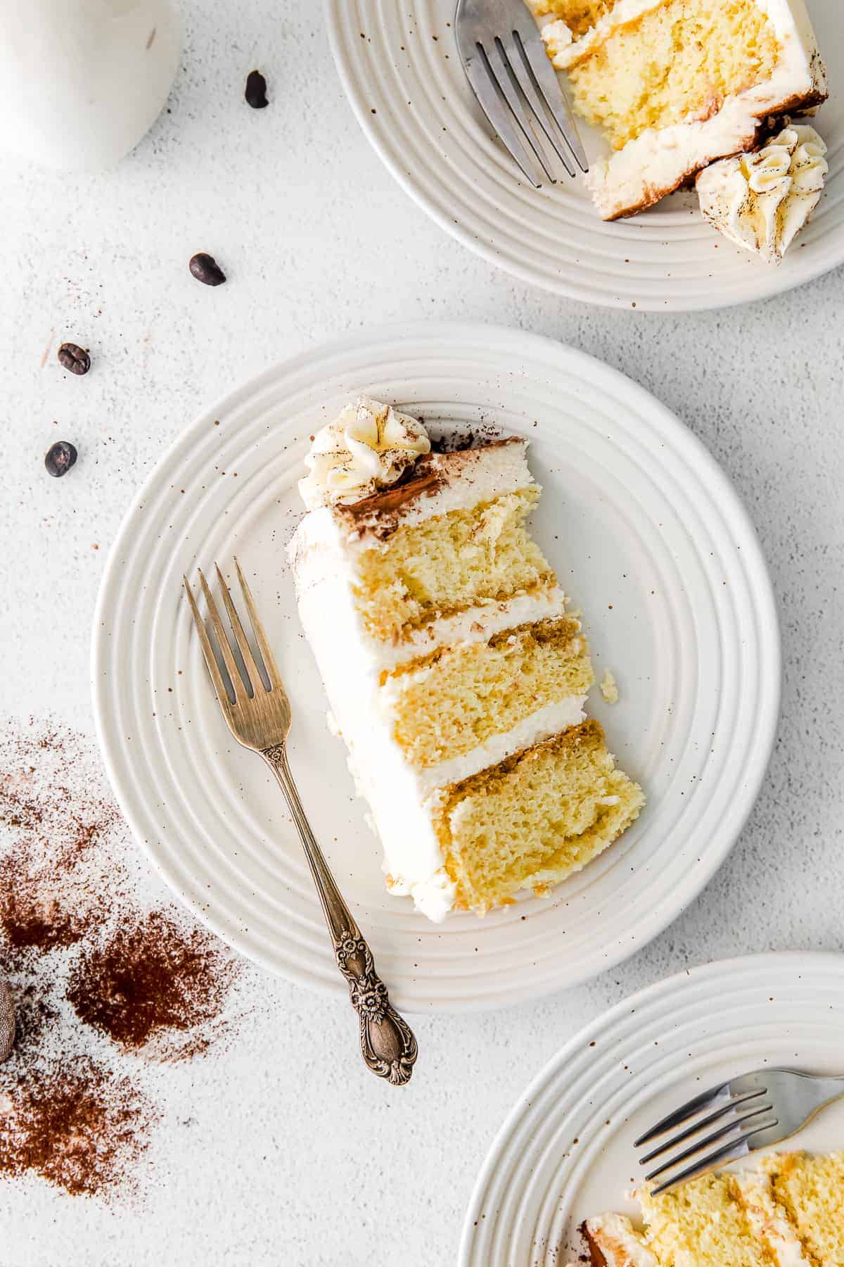 slice of tiramisu layer cake on a plate with a fork