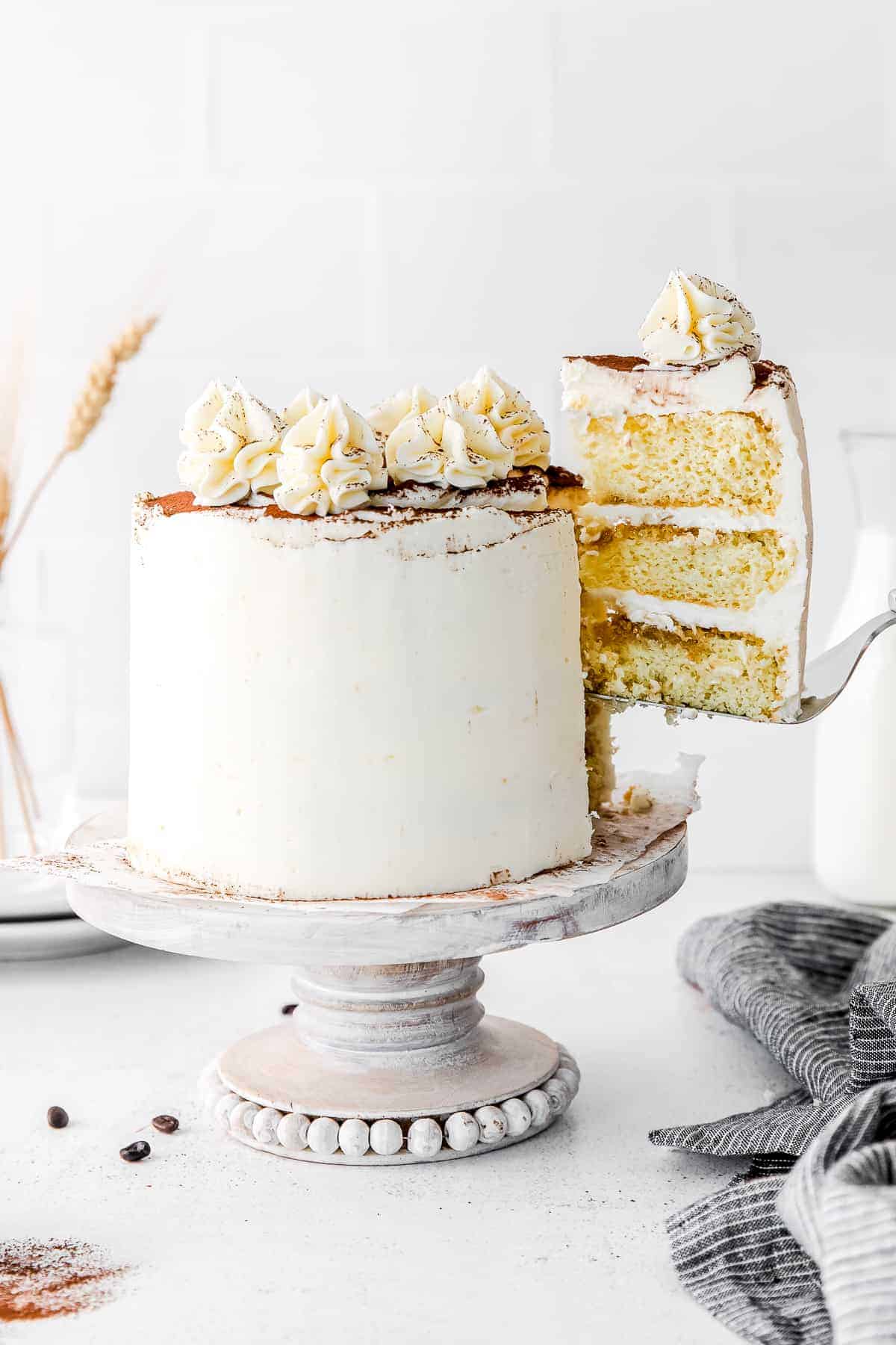 slice of tiramisu layer cake being removed from the cake