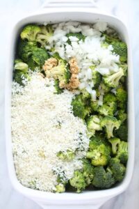 A white baking dish filled with broccoli and rice.