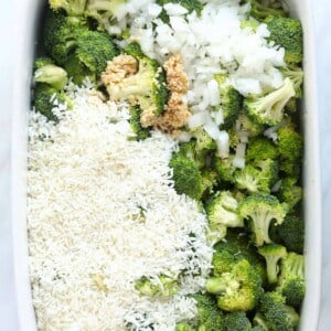 A white baking dish filled with broccoli and rice.