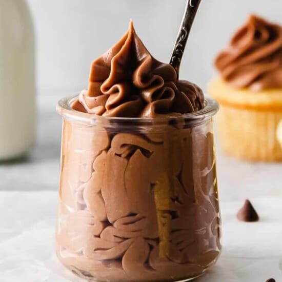 close up of chocolate cream cheese frosting with a spoon