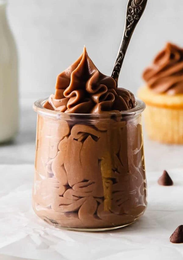 close up of chocolate cream cheese frosting with a spoon