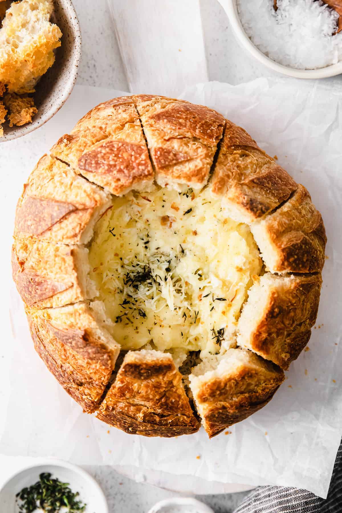 A simple baked brie in bread recipe made with a fresh sourdough loaf. Take your baked brie appetizer up a notch with this pull-apart idea. sourdough baked brie