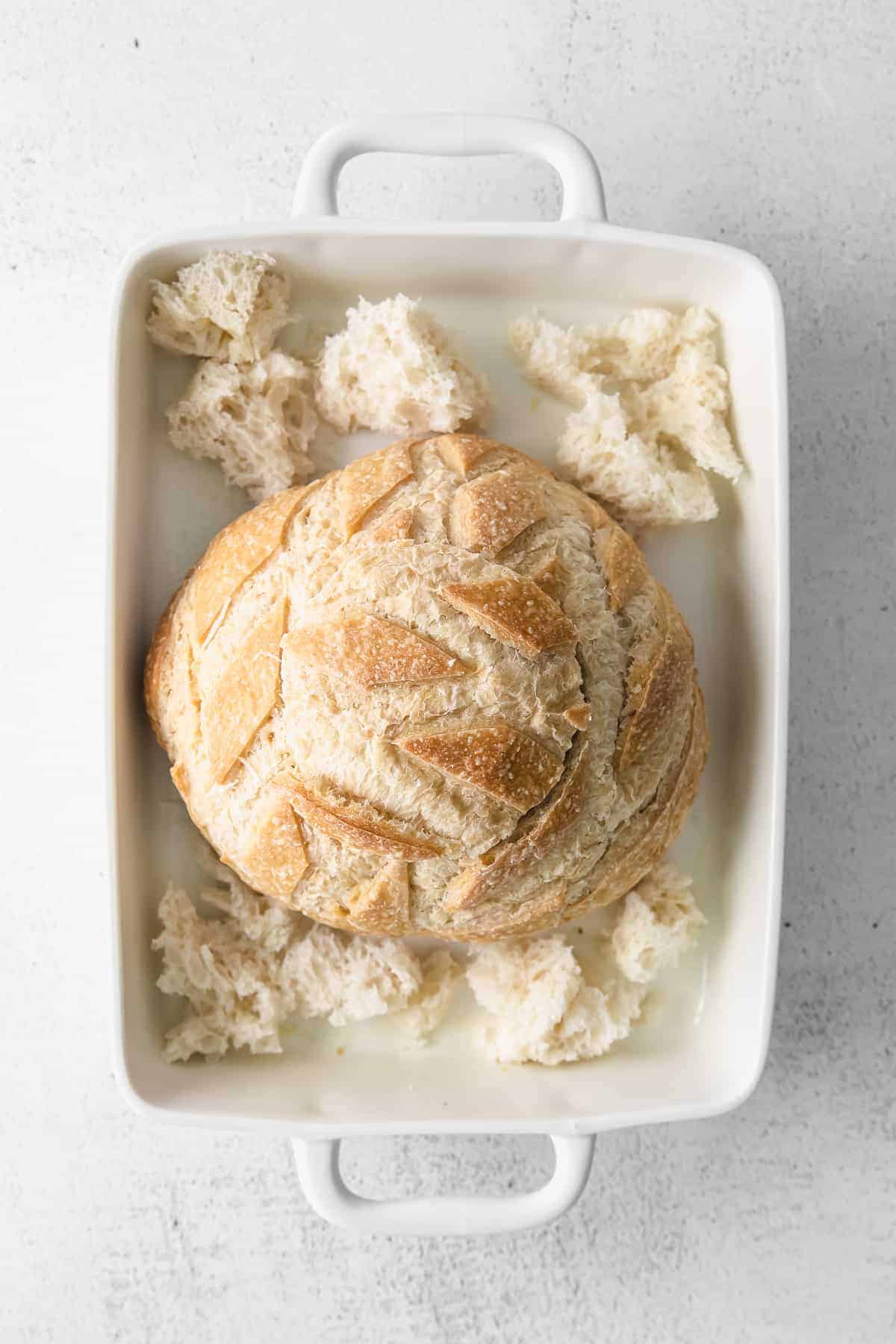 A simple baked brie in bread recipe made with a fresh sourdough loaf. Take your baked brie appetizer up a notch with this pull-apart idea. sourdough loaf in baking dish