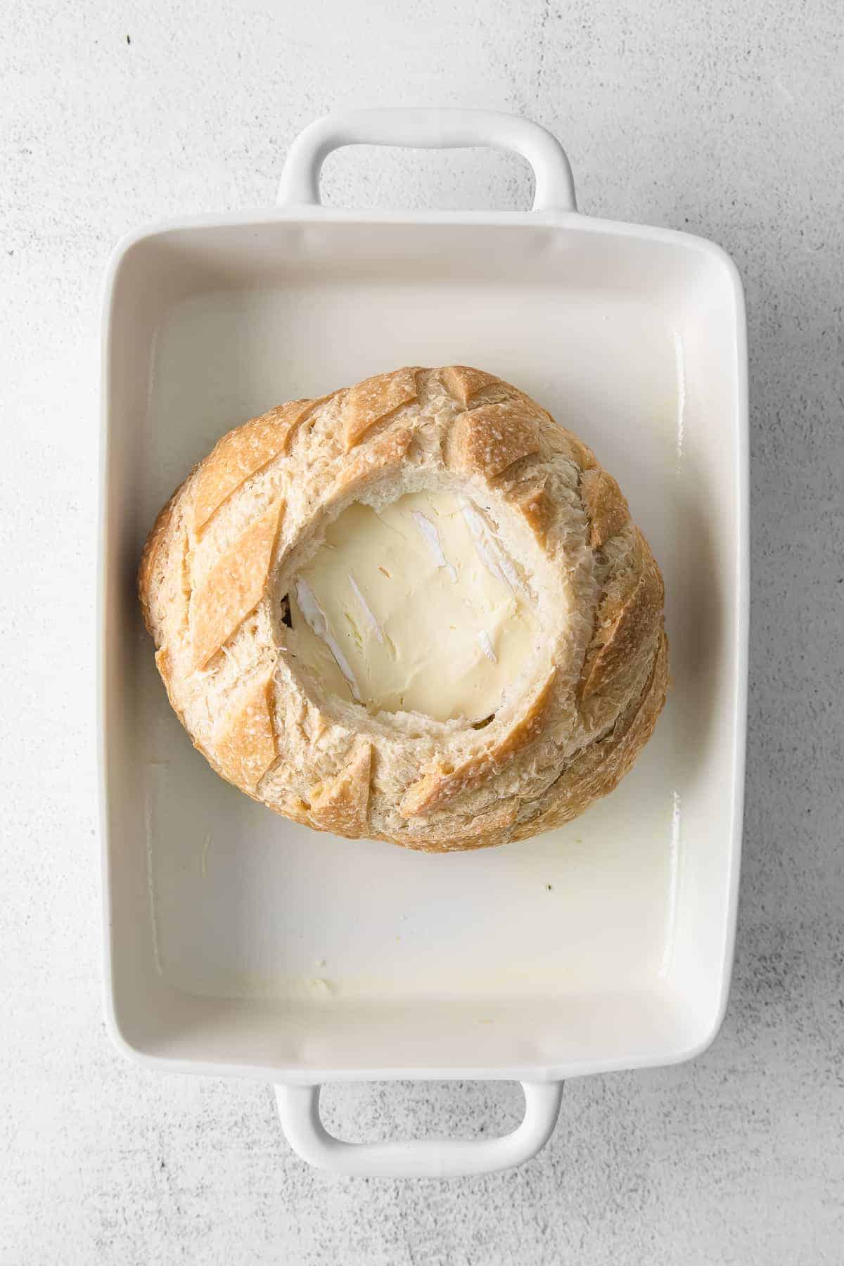 A simple baked brie in bread recipe made with a fresh sourdough loaf. Take your baked brie appetizer up a notch with this pull-apart idea. baked brie in sourdough bread