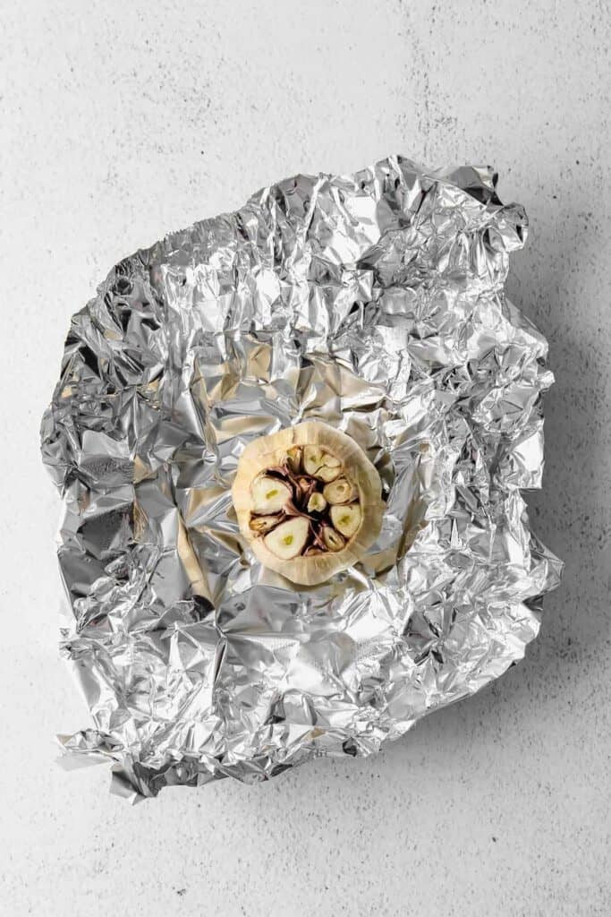 head of garlic on a piece of aluminum foil
