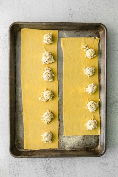 a cheese-filled pastry dough on a baking sheet.