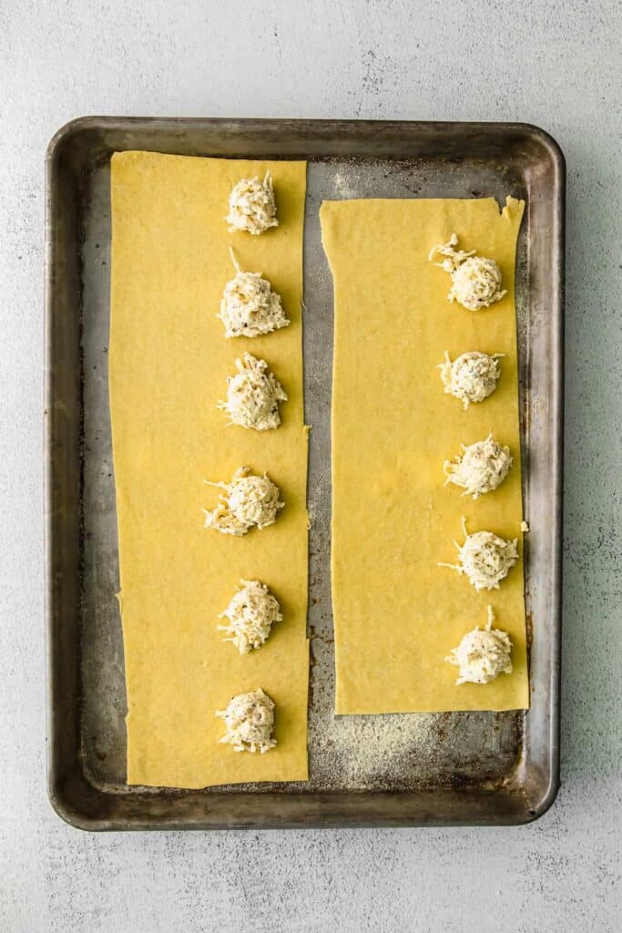 homemade cheese ravioli assembled on a baking sheet