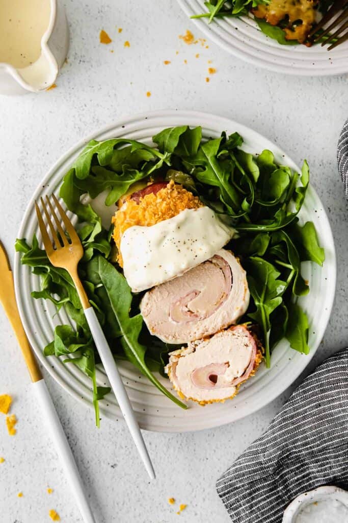 chicken cordon bleu on a plate with field greens