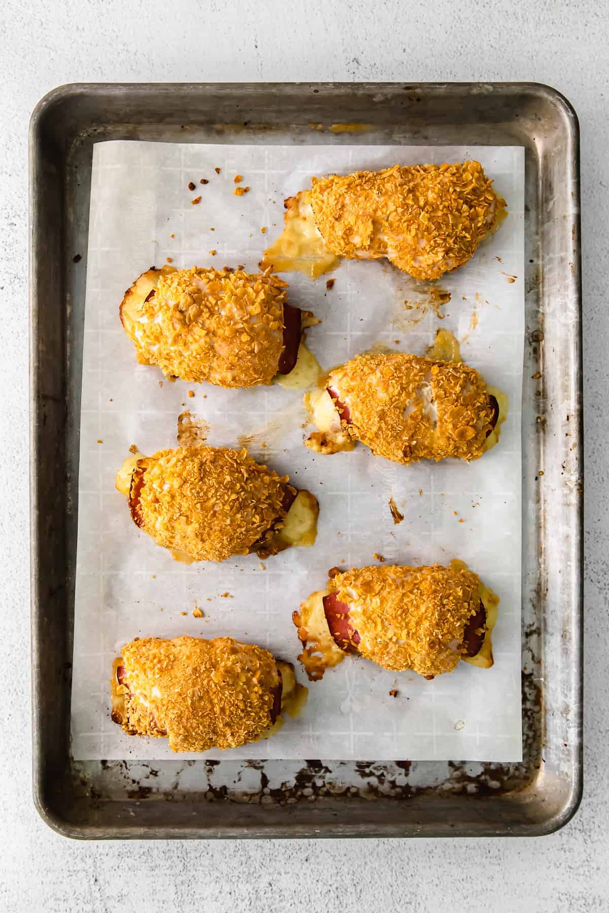 chicken cordon bleu assembled on a baking sheet