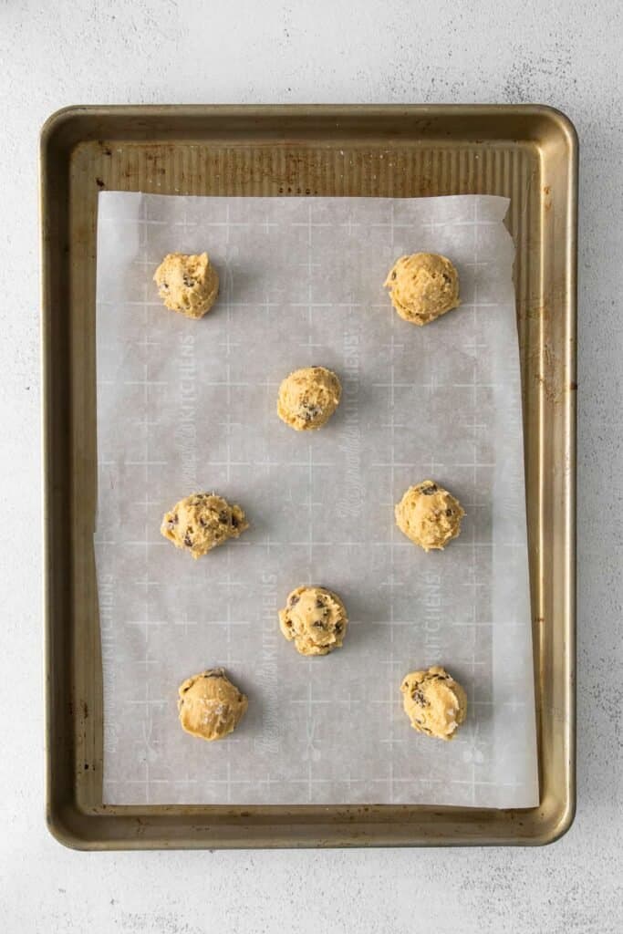 cream cheese chocolate chip cookie dough balls scooped on a cookie sheet