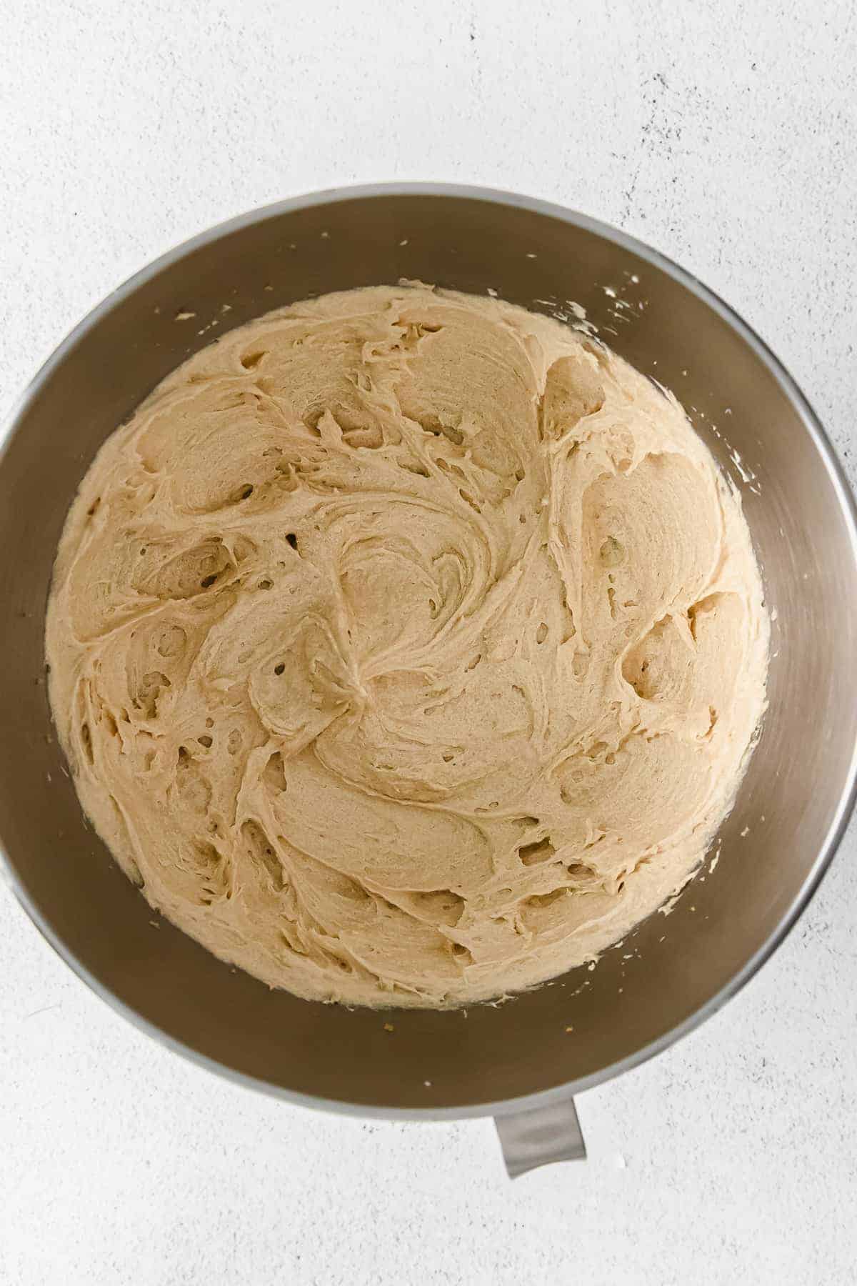 cream cheese chocolate chip cookie batter in a stand mixer bowl