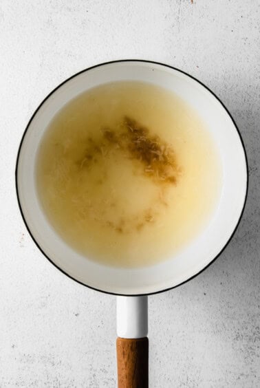 Making cheese fondue in a pot.